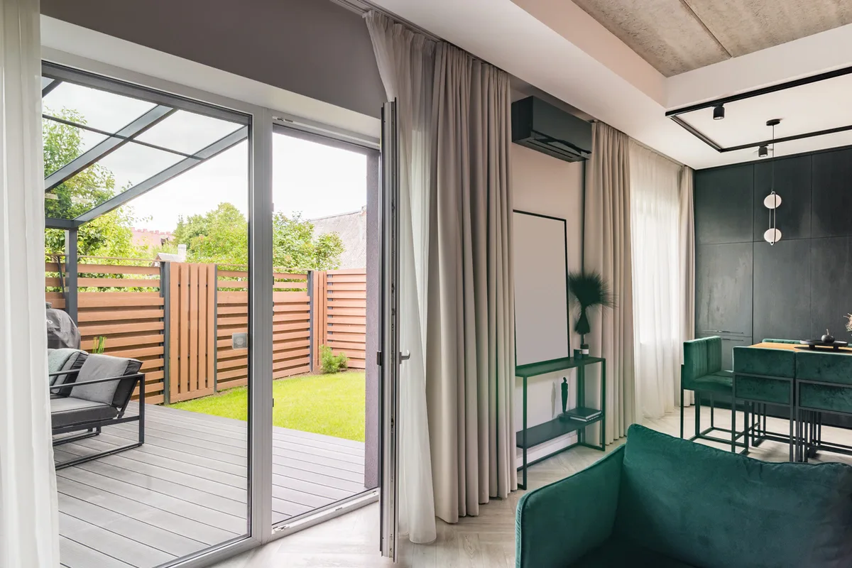 ameristar-patio-door-replacement-inland-empire Modern patio door opening from a bright living room to a sunny backyard terrace