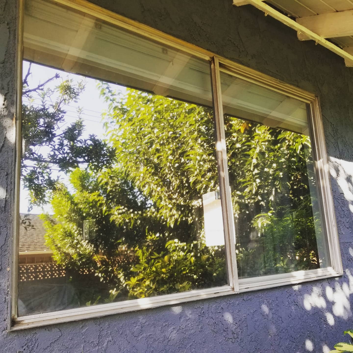 Energy-efficient sliding window installation on a residential home, improving natural light and outdoor views in Corona, CA.