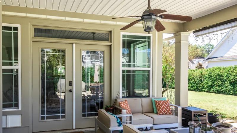 Bright covered patio with newly installed glass doors and energy-efficient windows, showcasing professional window replacement Corona, CA for enhanced comfort and style.