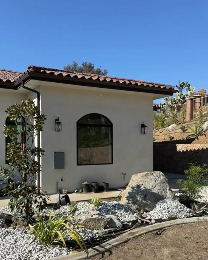 Modern stucco home in Corona, CA featuring an arched replacement window.
