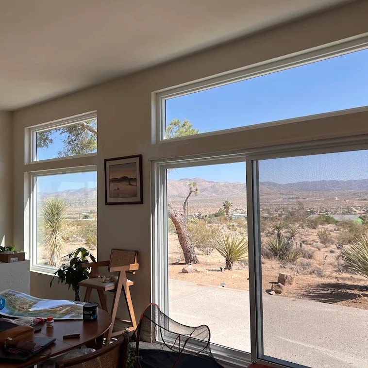 Large energy-efficient replacement windows with scenic desert views inside a modern home in Temecula, CA.