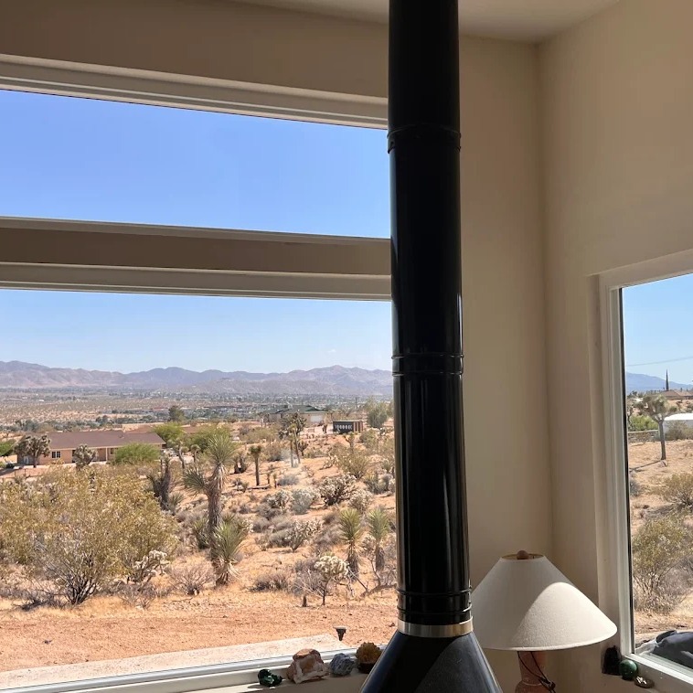 Large modern replacement windows with expansive desert views bring natural light into a home in Corona, CA.