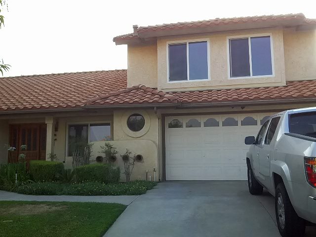 Two-story home with white replacement windows and tile roof in Riverside, CA
