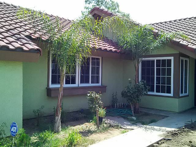 Exterior home with white replacement windows and palm landscaping in Temecula, CA
